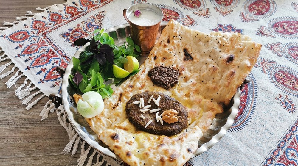 Traditional Isfahan Beryani served with fresh bread, herbs, and Persian spices