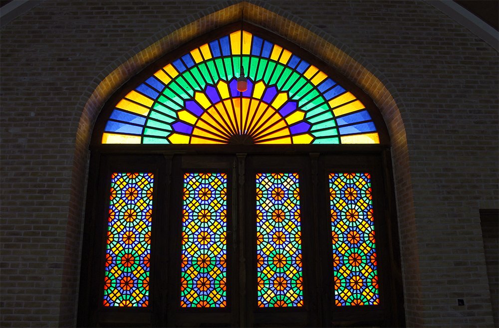 Colorful traditional windows of old houses in Yazd showcasing Persian architectural details