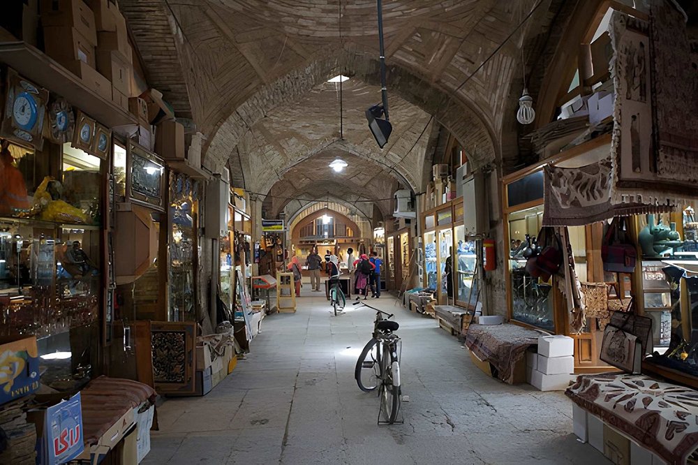 Isfahan travel guide featuring the Grand Bazaar with traditional Persian handicrafts, historic arches, and vibrant shopping alleys near Naqsh-e Jahan Square