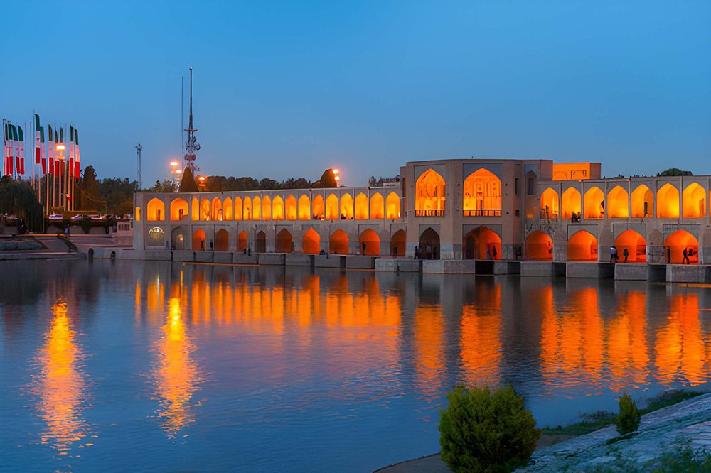 Isfahan travel guide featuring Khaju Bridge, a historic Safavid-era bridge with elegant arches over the Zayandeh Rud River in Iran